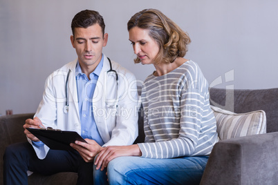 Doctor discussing a medical report with woman