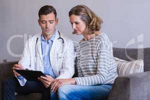 Doctor discussing a medical report with woman