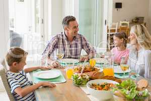 Family having meal on dinning table at home