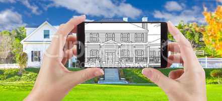 Hands Holding Smart Phone Displaying Drawing of Home Photo Behin