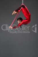 Pretty slim gymnast with red hoop studio shot