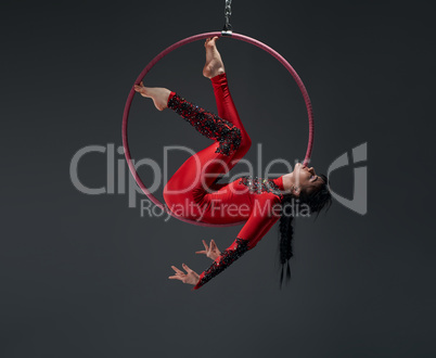 Young slim gymnast with red hoop artistic portrait