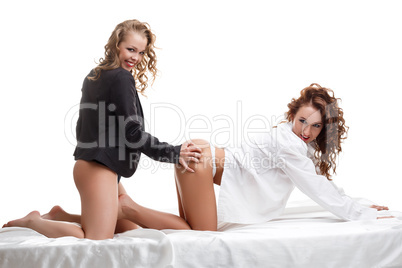 Lesbian women posing in bed, studio shoot