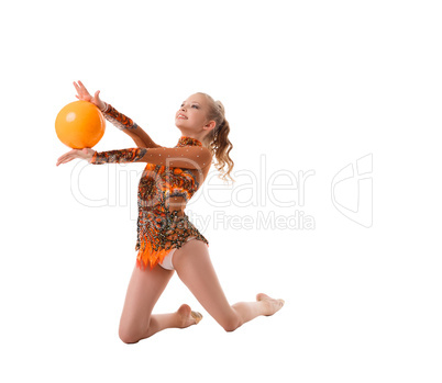 Young slim gymnast with yellow ball studio shot