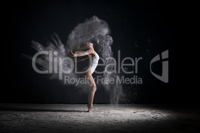 Slender blonde dancing in white dust studio shot