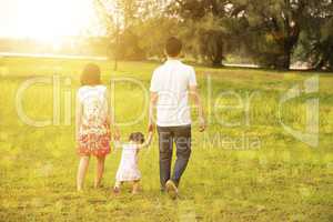 Family walking at outdoor park in sunset