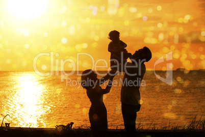 Silhouette of family in outdoor beach sunset