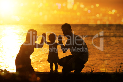 Silhouette family in outdoor sunset