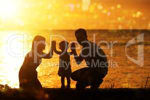 Silhouette family in outdoor sunset