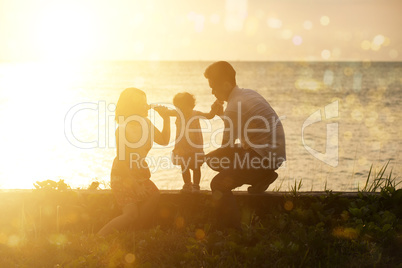 Family outdoor fun in sunset at beach