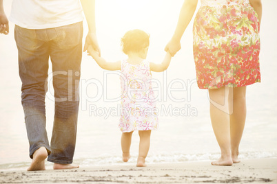 Family holding hands on beach