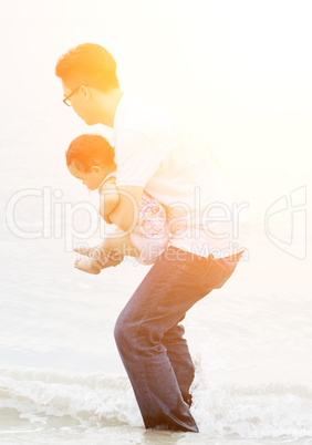 Family playing water on beach