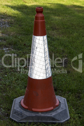 Red traffic cone on grass