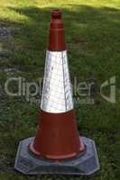 Red traffic cone on grass