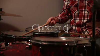 Expressive drummer playing drums with drum stick