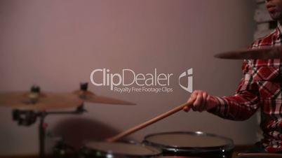 Young hipster drummer juggling drumsticks