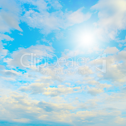 Sun in blue sky and white clouds.