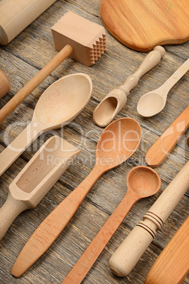 Set wooden kitchen utensils on wooden table.
