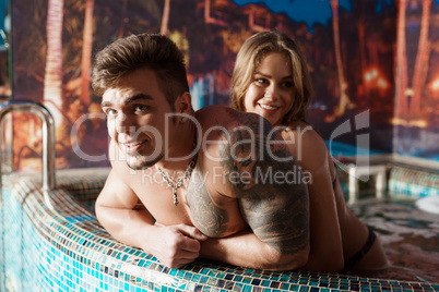 Sexy couple relaxing in luxurious swimmingpool