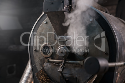 Coffee bean roaster at work in a production room