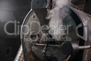 Coffee bean roaster at work in a production room