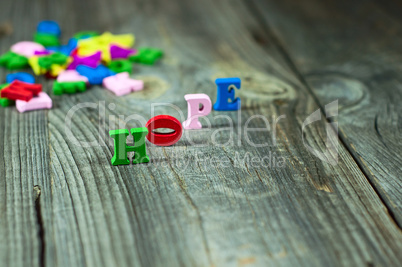 Words of hope from small wooden letters on a gray surface