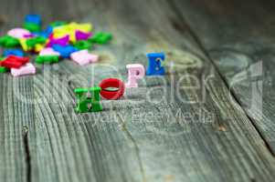 Words of hope from small wooden letters on a gray surface