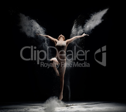 Slender girl dancing in white powder cloud