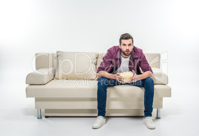 Man sitting on couch with popcorn