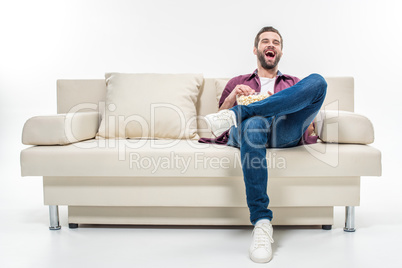 Man sitting on couch with popcorn
