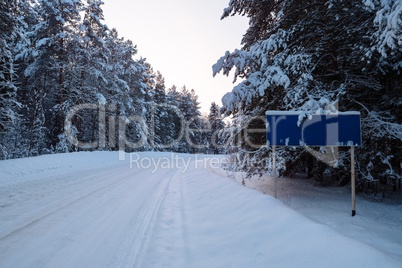 Winter road landscape with traffic sign