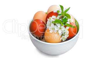 Easter eggs in a ceramic vase on a white background.
