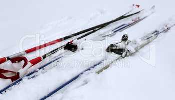 Skis and ski poles in the snow.