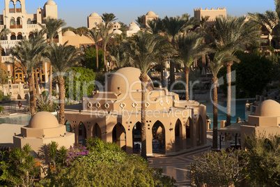 An oasis of palm trees and greenery photo. Houses along the beach in Makadi, Egypt