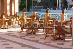 Wooden tables in a outdoor restaurant photo near water pool