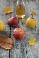 Apple cider in  bottle,  and fresh apples on wooden background.A