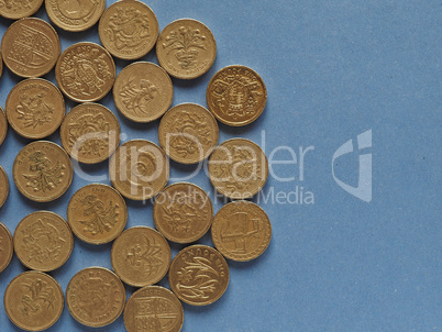 Pound coins, United Kingdom over blue with copy space