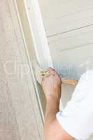 Professional Painter Cutting In With Brush to Paint Garage Door