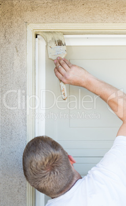 Professional Painter Cutting In With Brush to Paint Garage Door