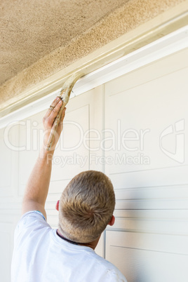 Professional Painter Cutting In With Brush to Paint Garage Door