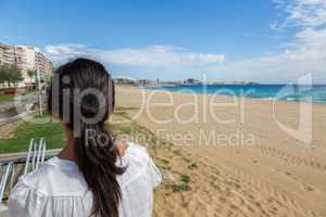 Girl on the empty beach in Spain at autumntime
