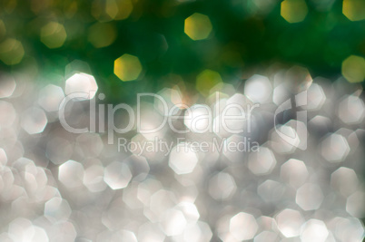 Abstract blurred background with silver and green bokeh