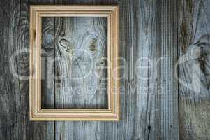 empty wooden frame on aged gray wooden wall