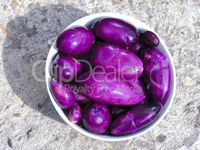 Bowl of freshly picked and washed purple potatoes