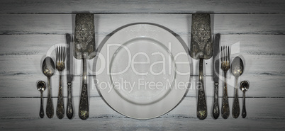 Vintage cutlery on a white wooden surface