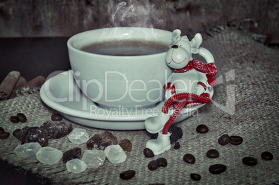 cup of hot coffee with a toy