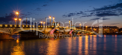 Night cityscape with river and bridge in Saint-Petersburg.