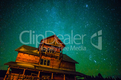 Milky way over wooden house