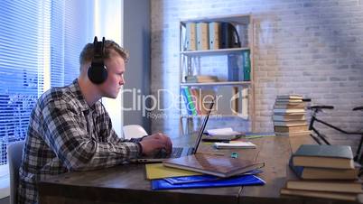 Student learning online with headphones and laptop