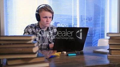 Serious student e-learning online with laptop